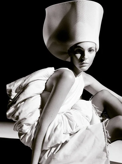 Vittoria Ceretti wearing a white sculptural hat and outfit for Beyond Noise fashion editorial photography by Anthony Seklaoui.