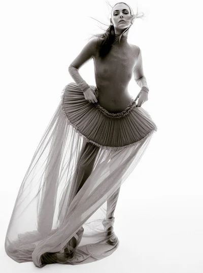 Model Vittoria Ceretti wearing sheer tulle skirt and form-fitting top against a seamless white background for Beyond Noise.