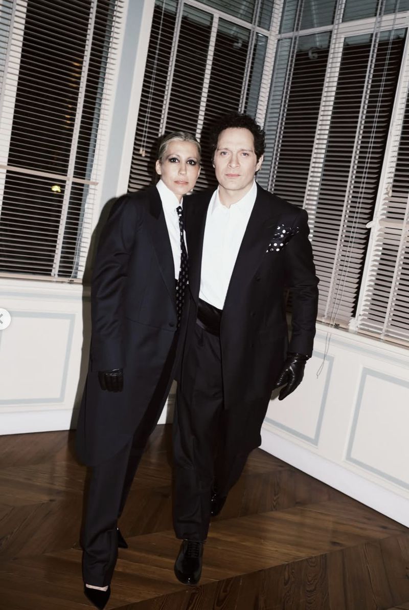 Malika Ayane and Claudio Santamaria wearing matching black suits and white shirts indoors for Vogue Italia