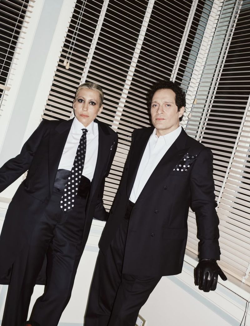 Malika Ayane and Claudio Santamaria wearing matching black suits and polka dot ties in a Vogue Italia editorial by Maria Clara Macri.