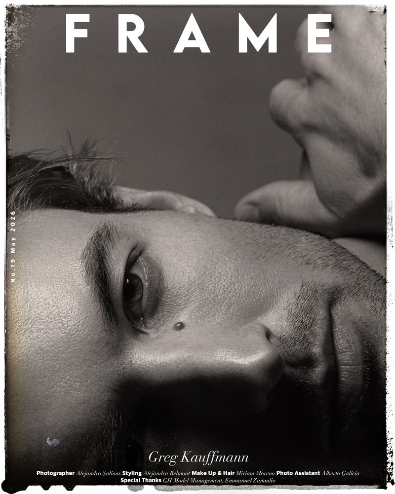 Magazine cover featuring a close-up of a man's face, partially obscured by a hand, with the word 'FRAME' prominently displayed at the top.