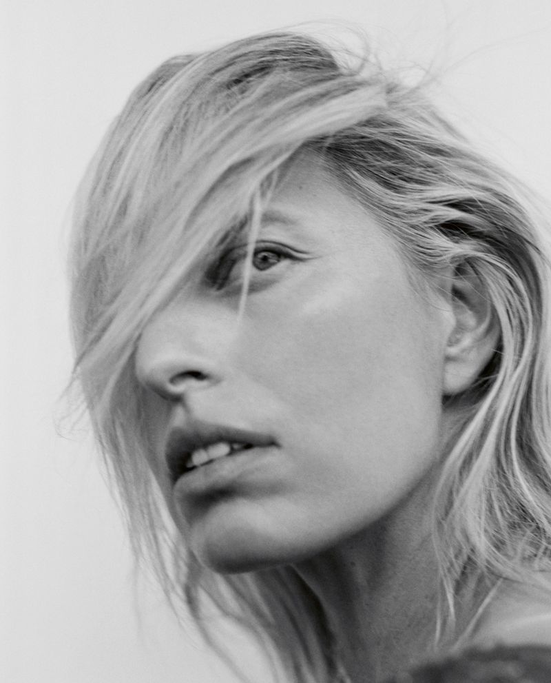 Close-up monochrome portrait of Karolina Kurkova with blonde hair partially obscuring her face for Vogue Czechoslovakia.