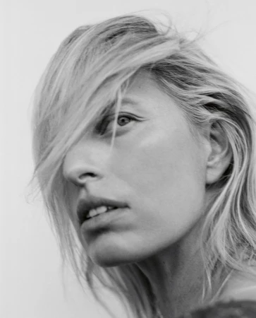 Close-up monochrome portrait of Karolina Kurkova with blonde hair partially obscuring her face for Vogue Czechoslovakia.