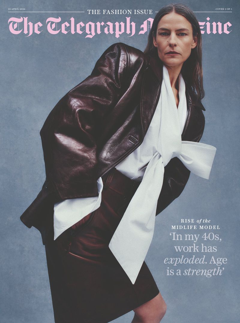 Model in a dark leather jacket and white bow blouse against a textured blue background for Telegraph Magazine