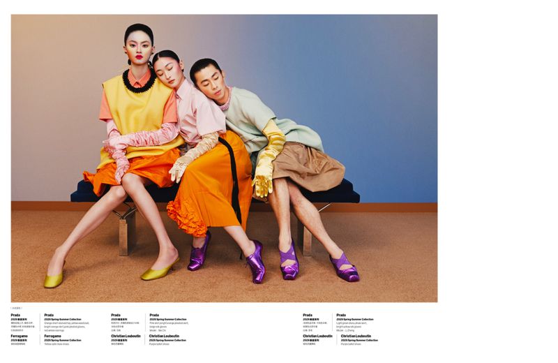Three models in colorful designer clothing seated on a bench against a gradient studio wall for W Magazine China