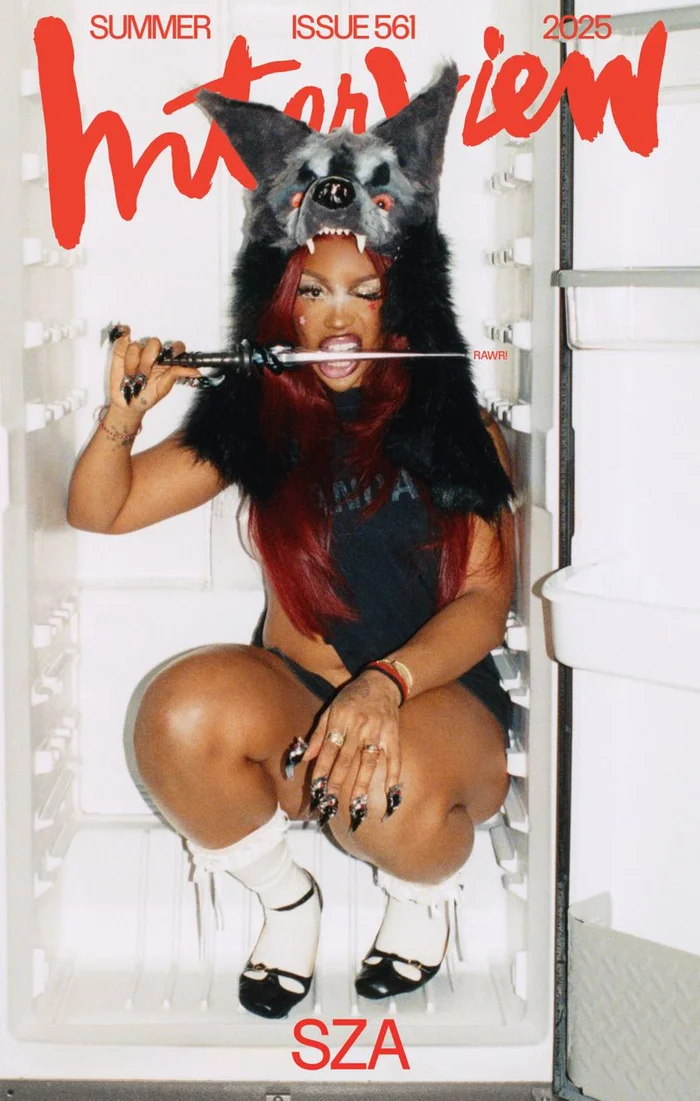 SZA wearing a furry wolf hat and holding a dagger while crouching inside an open refrigerator for Interview Magazine.