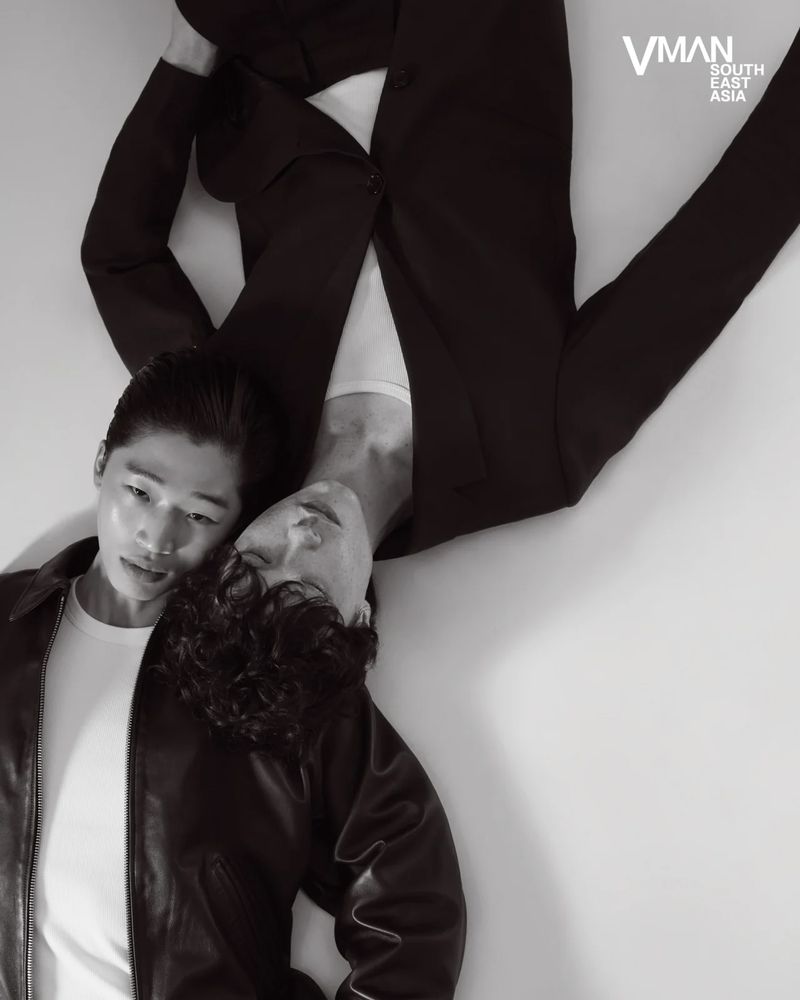 Two male models lying head to head on a white floor for V Man Sea editorial photographed by William Ferchichi.