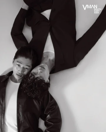 Two male models lying head to head on a white floor for V Man Sea editorial photographed by William Ferchichi.