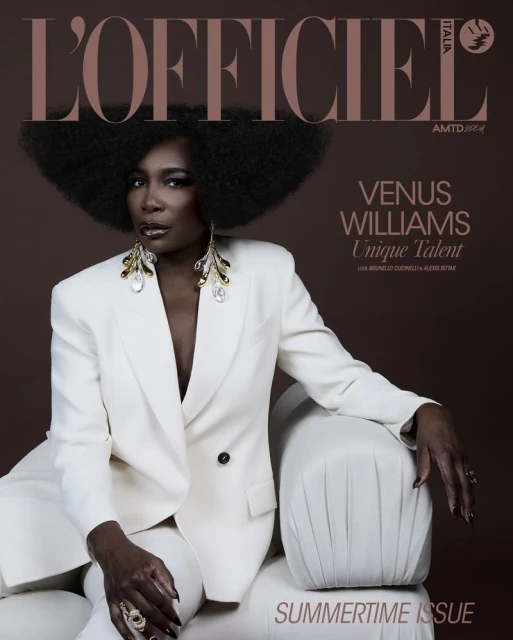 Venus Williams, an African-American woman, poses in a white suit on a sofa for L'Officiel Italia, with an afro and statement earrings.