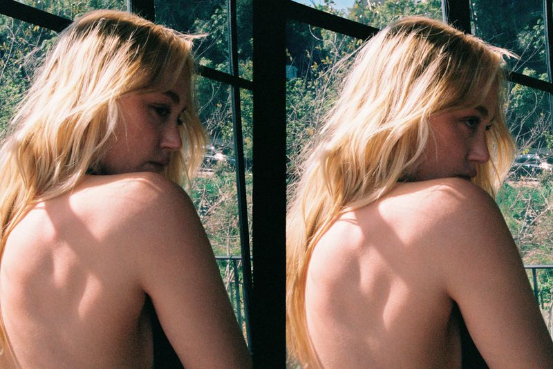 Maika Monroe photographed by Dana Boulos for HERO USA, featuring a portrait against a window.