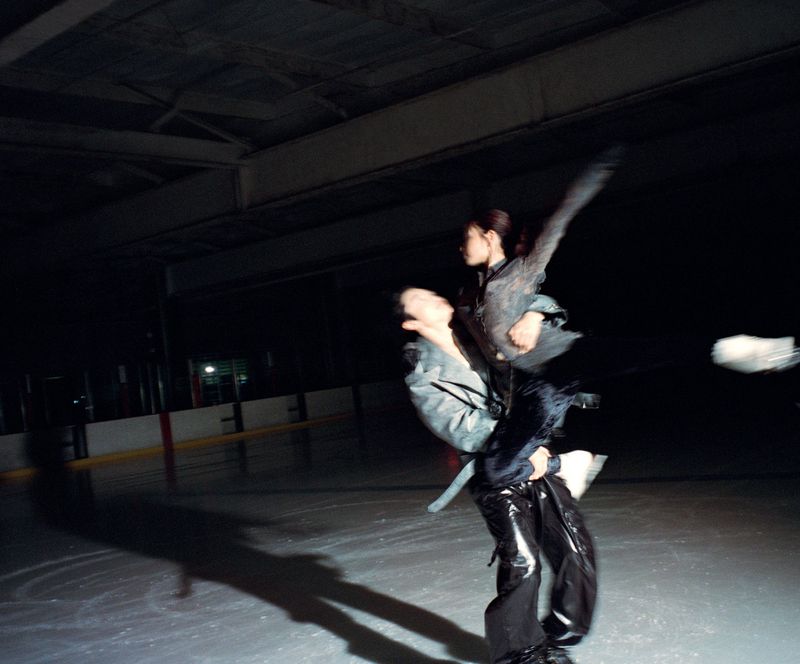 Alex and Maia Shibutani performing a dramatic lift on an indoor ice rink for HERO USA, photographed by Daria Kobayashi Ritch.