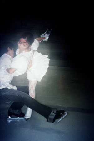 Alex and Maia Shibutani ice skating in white attire during an evening shoot captured by Daria Kobayashi Ritch for HERO USA.