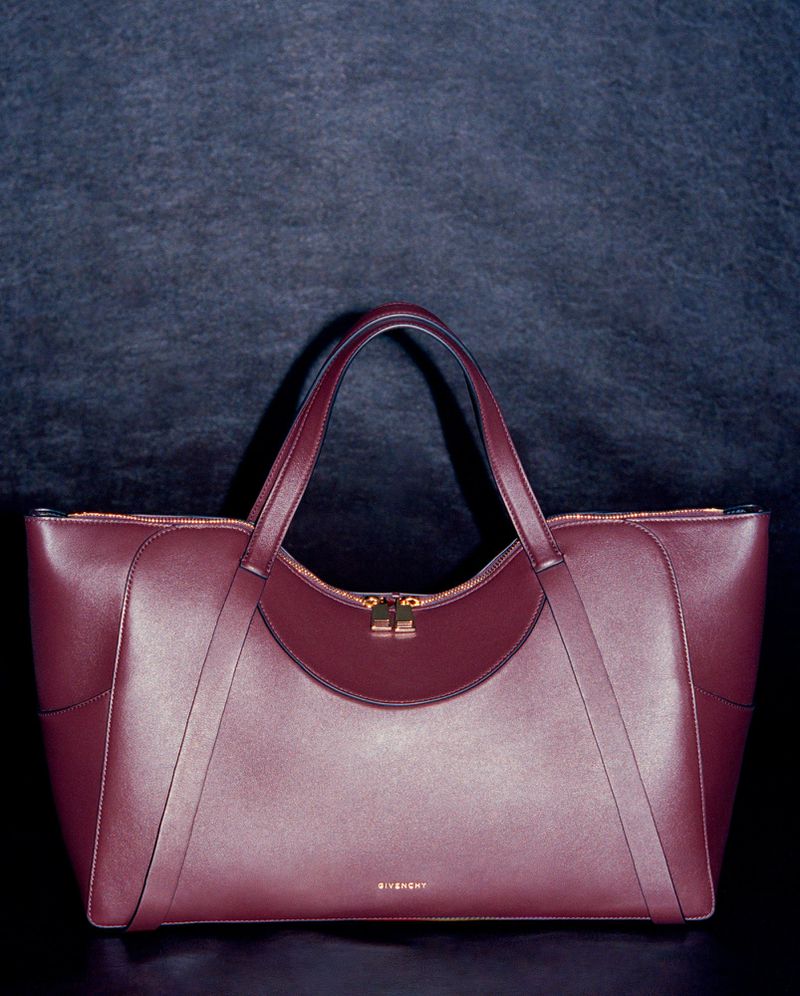 Burgundy leather tote bag centered against a dark textured background for HERO USA project Things That Choose You.