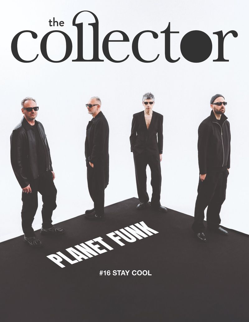 Four men in black outfits and sunglasses standing on a dark platform against a white background for The Collector Magazine