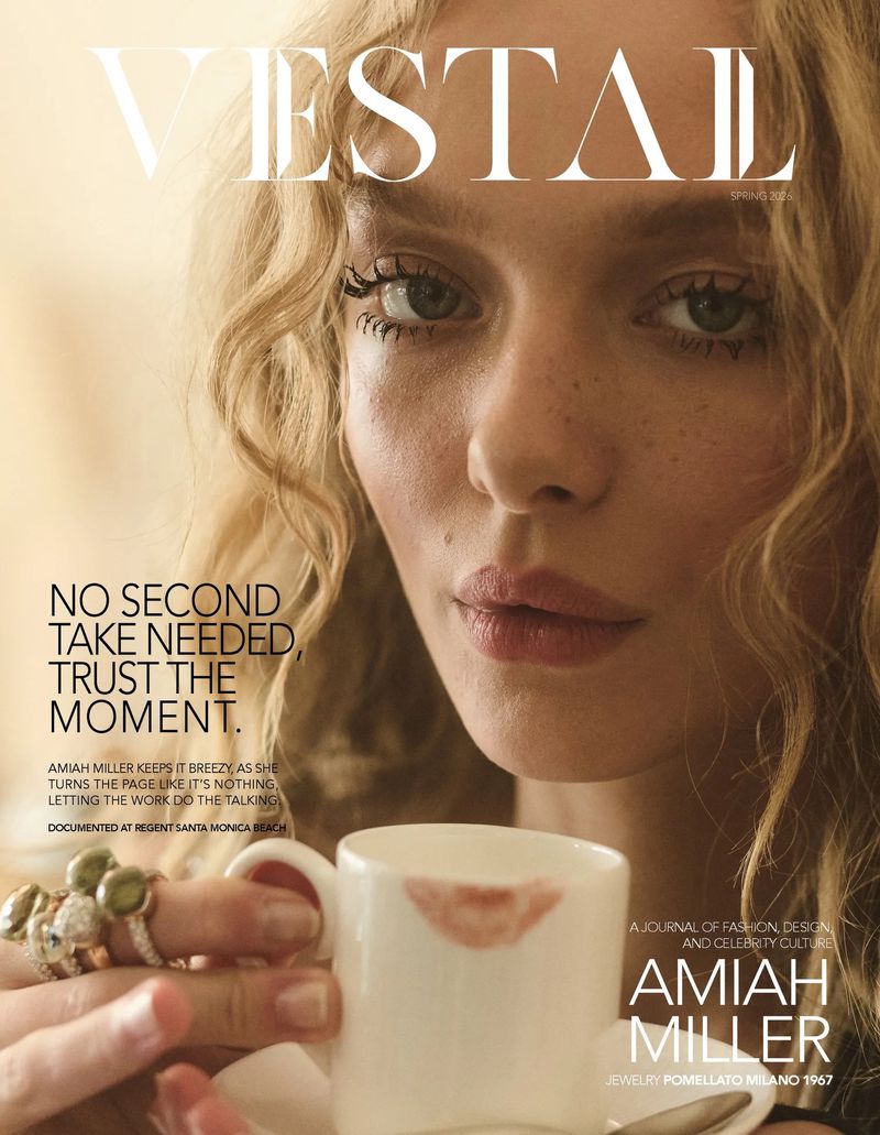 Magazine cover featuring a close-up of a fair-skinned woman with curly blonde hair, holding a lipstick-stained teacup to her lips.