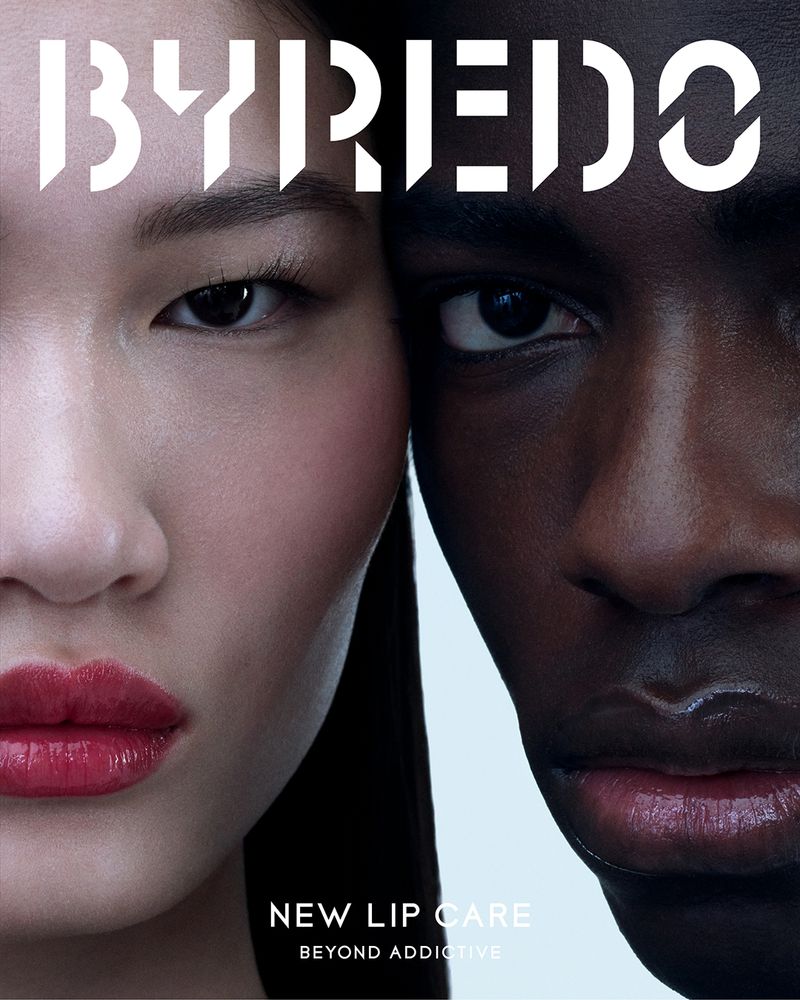 Beauty advertisement featuring a light-skinned Asian woman and a dark-skinned Black man, close-up, with the BYREDO logo at the top.