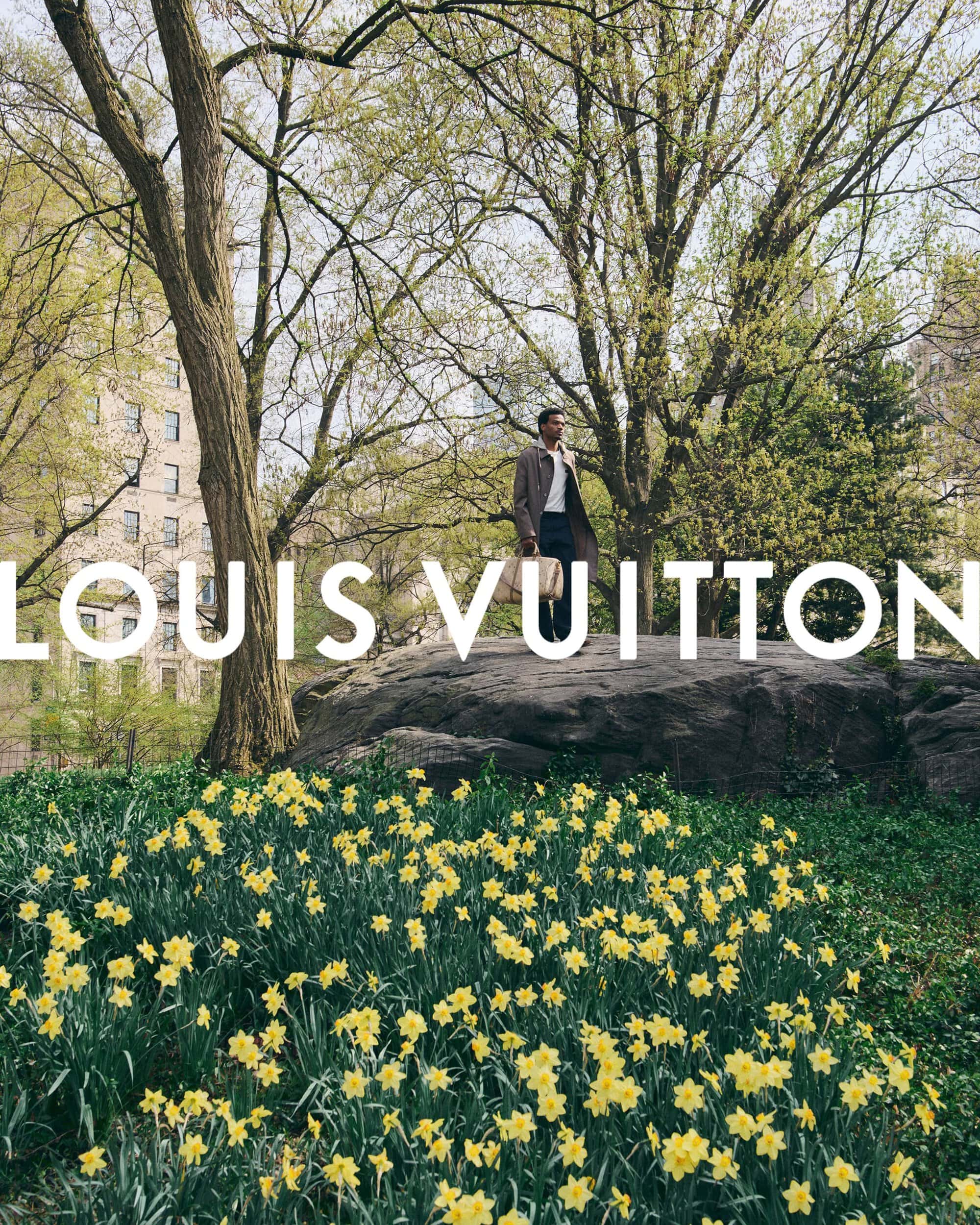 Tyshawn Jones standing on a large rock in Central Park surrounded by yellow flowers for Louis Vuitton Pre-Fall 2026