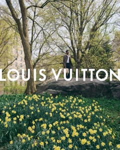 Tyshawn Jones standing on a large rock in Central Park surrounded by yellow flowers for Louis Vuitton Pre-Fall 2026
