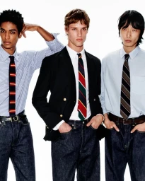 Three male models wearing button-down shirts, ties, and dark denim jeans against a bright white background for Mr Porter.