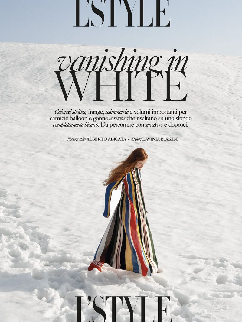 Fashion editorial: A woman in a colorful striped dress walks on snowy ground, beneath the magazine title "L'Style".