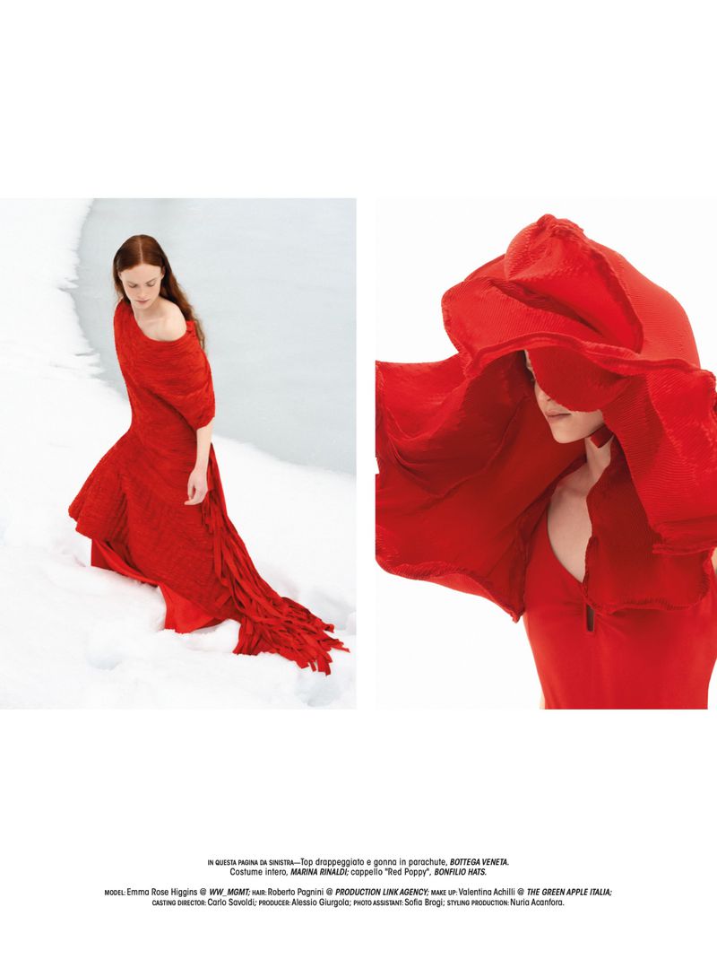 Model Emma Rose Higgins wearing a flowing red dress against a snowy backdrop in Vanishing in White for L'Officiel Italia
