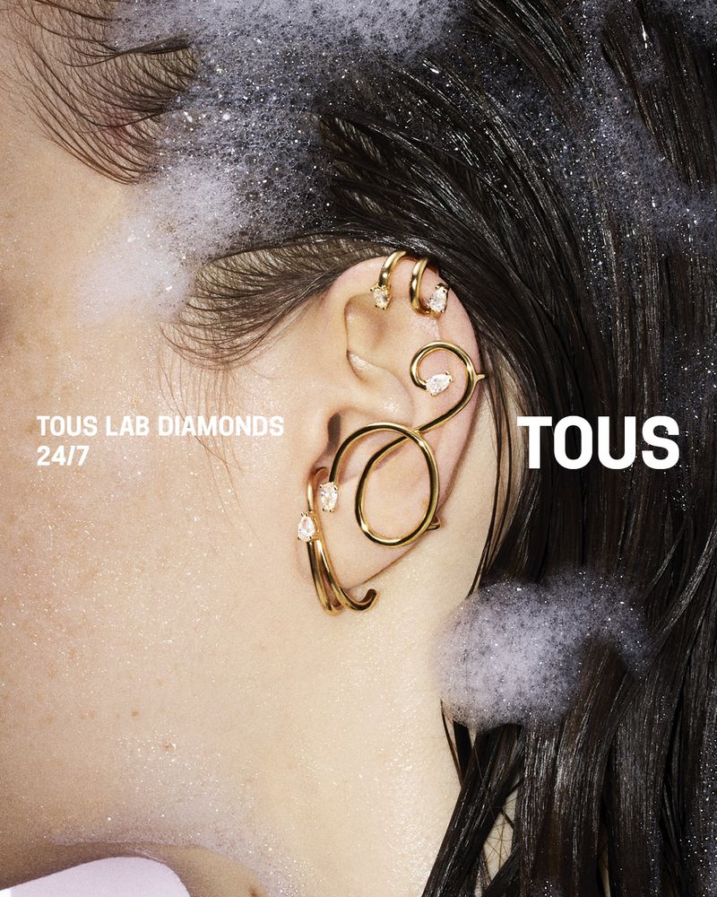Close-up profile of a woman with wet dark hair adorned with gold ear cuffs and lab-grown diamonds for Tous Lab Diamonds campaign.