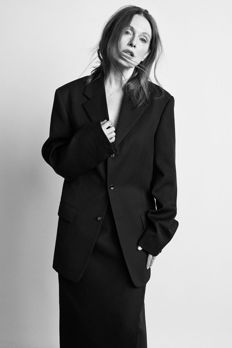 Julianne Moore wearing an oversized black blazer against a light seamless studio background