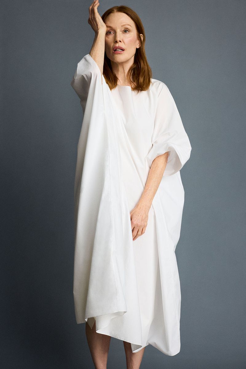 Julianne Moore posing in a white tunic dress against a solid grey background for the Open Concept project by Family Style