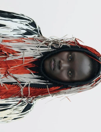 Model Aluel Keror wearing a fringed hooded knit garment in Exit Magazine editorial Fringe Benefit.