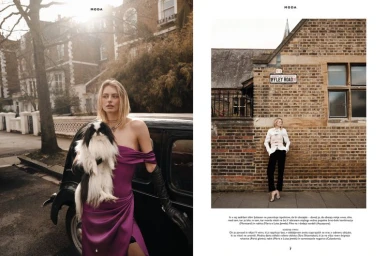 Editorial double-page spread featuring a woman in a purple dress holding a dog next to a vintage car and standing by a brick wall.