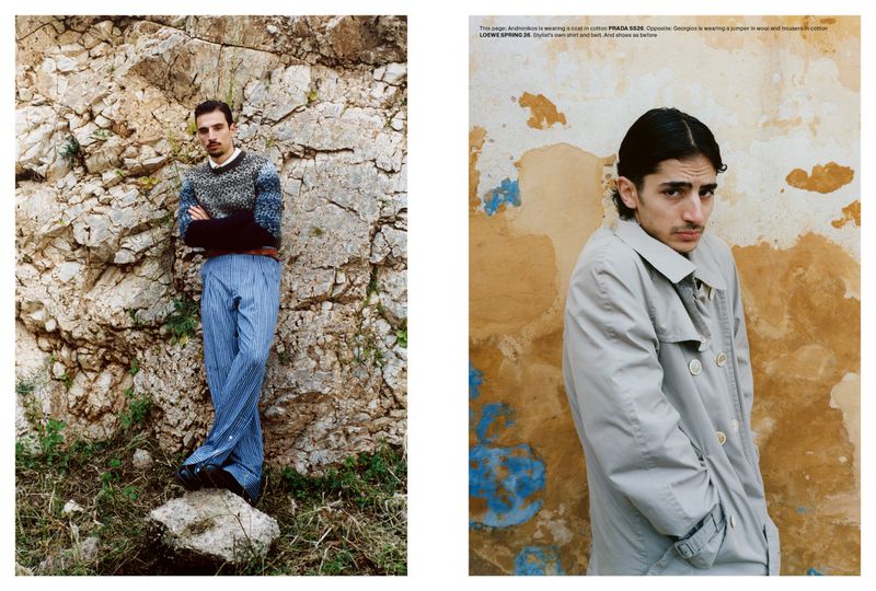 Two-page magazine spread featuring two men modeling styled menswear outdoors against rocky natural stone and rustic painted wall backgrounds.