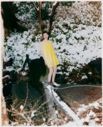 Model in a yellow dress standing outdoors in a snow-covered park for Grazia Malaysia Tokyo Park project
