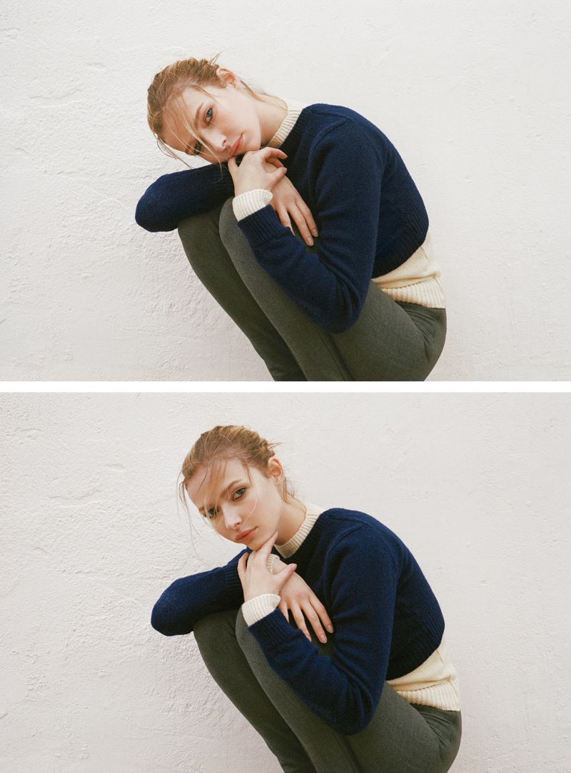 Model Apple Martin in a dark blue sweater and olive trousers posing against a white wall for American Vogue.