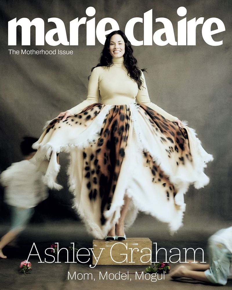 Ashley Graham standing on a wooden block wearing a turtleneck and patterned skirt for Marie Claire U.S. magazine.