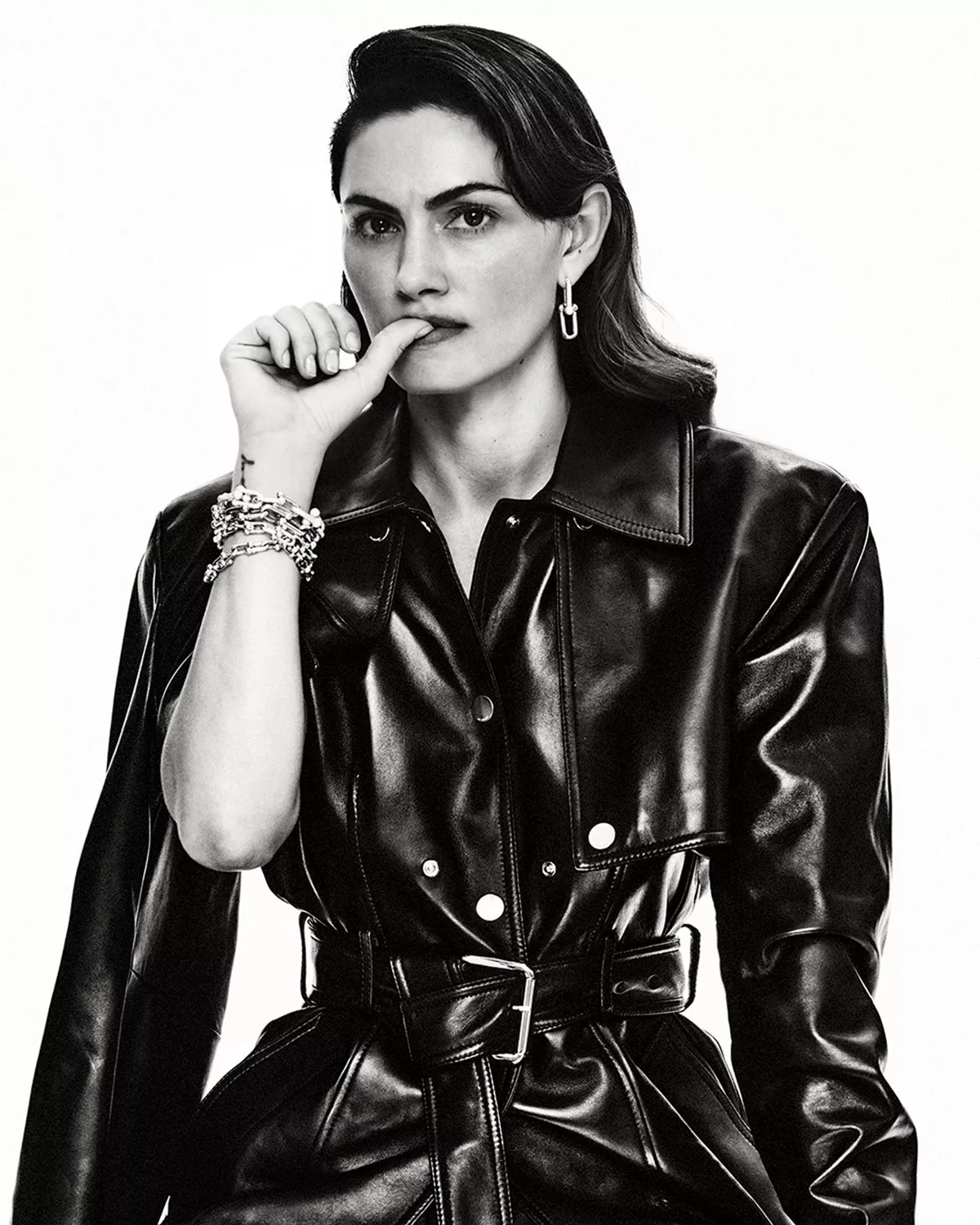 Phoebe Tonkin wearing a black leather coat against a white background for Harper's Bazaar Australia