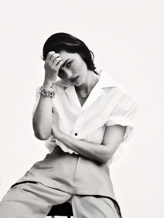Phoebe Tonkin wearing a white short-sleeve shirt against a white seamless background for Harper's Bazaar Australia.