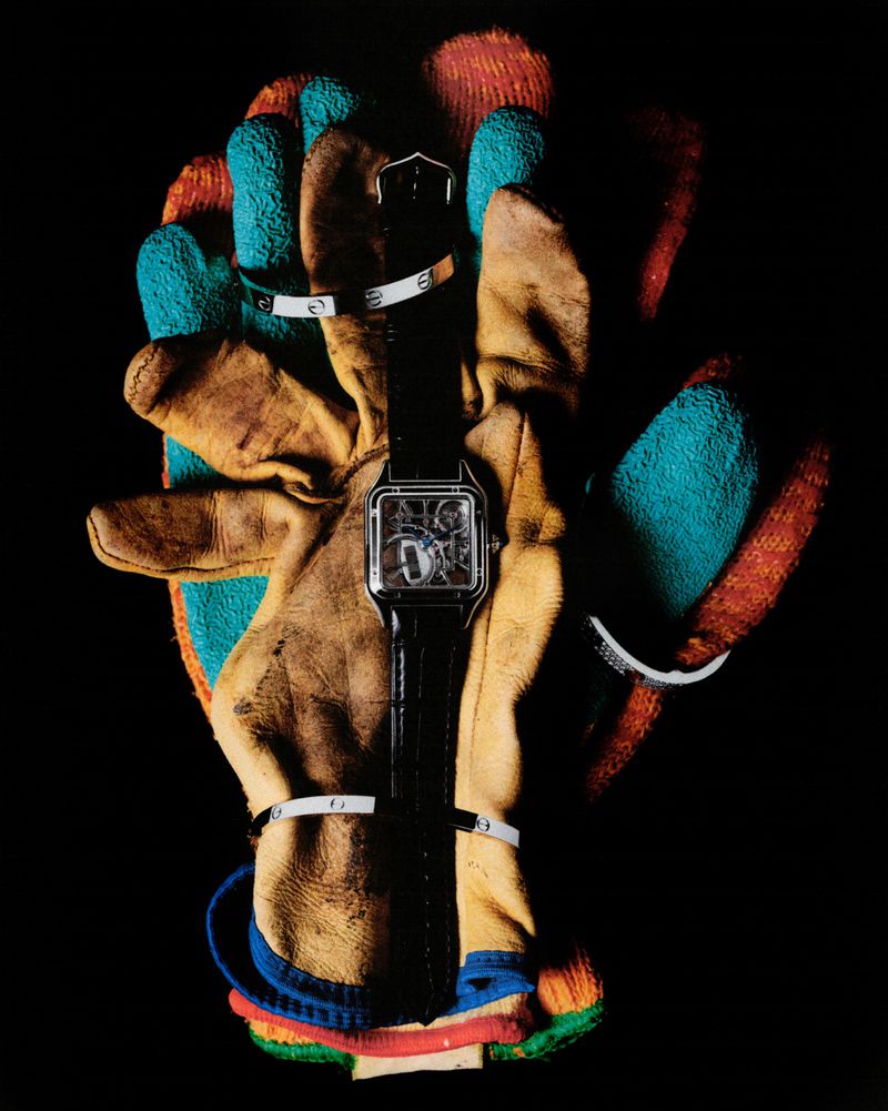 Wristwatch on a leather glove with metal bracelets in a studio setting, showcasing fashion and accessory photography.