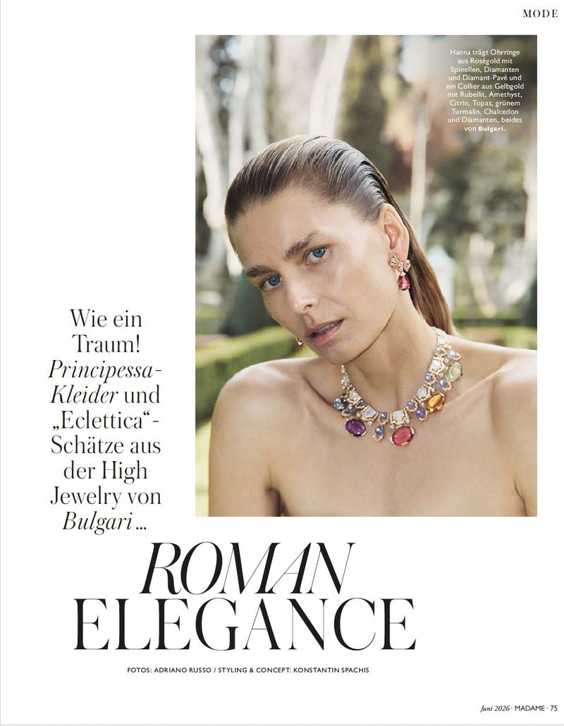 Model Hana Soukupova wearing a colorful gemstone necklace and earrings against an outdoor park background for Madame Germany.