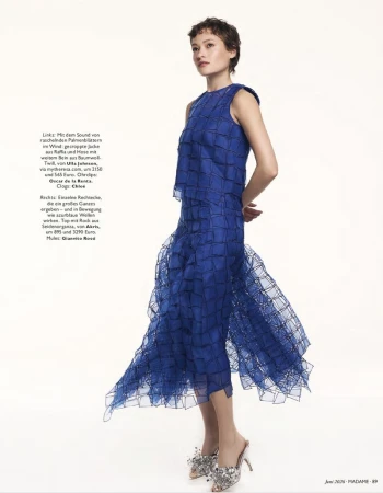 Model wearing a structured blue textured sleeveless top and matching midi skirt against a white background
