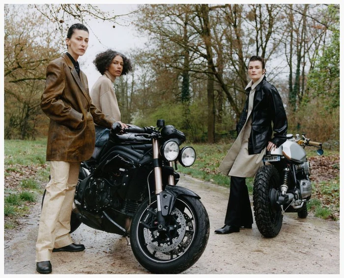 Three models posing outdoors with motorcycles on a wooded path for the Family Style Pressure Release project.