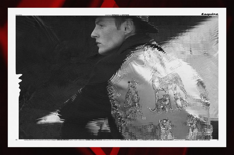 Black and white editorial fashion portrait of a male model wearing a patterned jacket in profile.