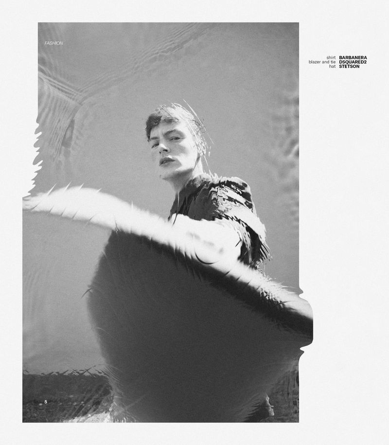 Monochrome fashion editorial portrait of a male model with a blurred low angle perspective.