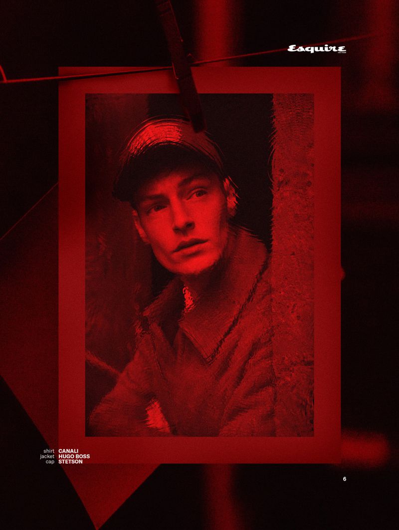 A man wearing a cap and jacket in a red tinted portrait for Esquire Vietnam Crimson Frontier