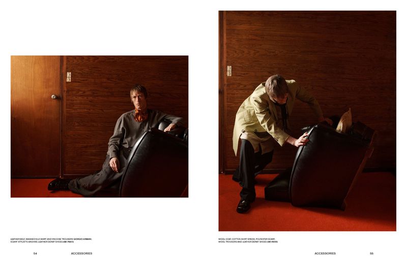 Editorial spread featuring two figures in retro attire interacting with dark leather chairs in a wood-paneled room