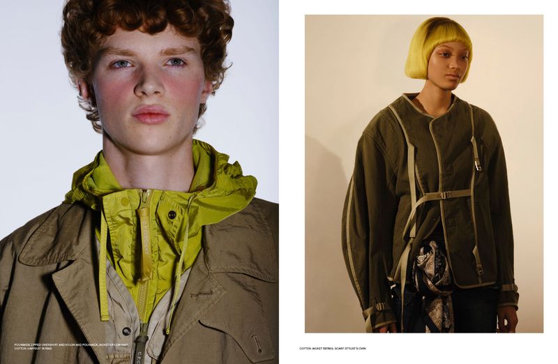 Close-up portrait of a male model wearing an olive jacket and lime green hooded overshirt against a neutral background