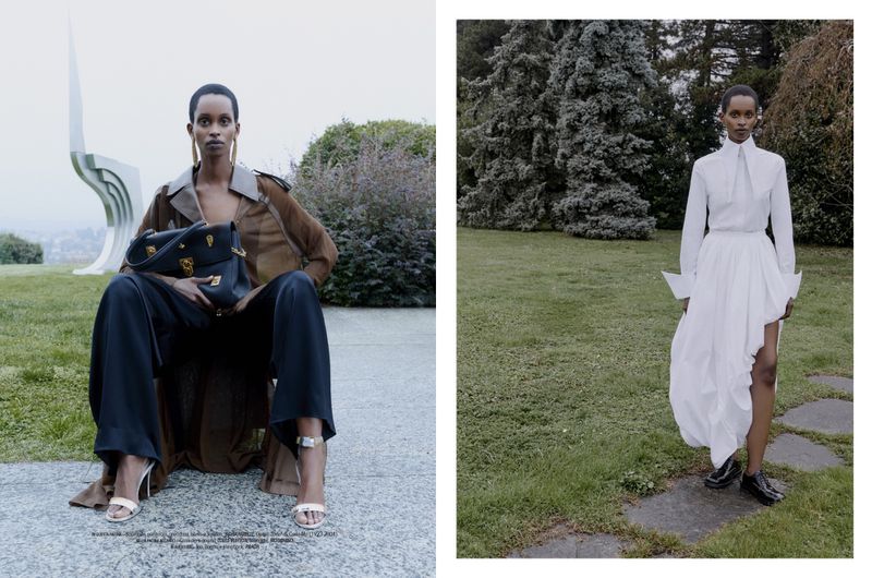 Outdoor fashion shoot features an African female model posing in designer clothing and jewelry, accessorized with a black handbag.