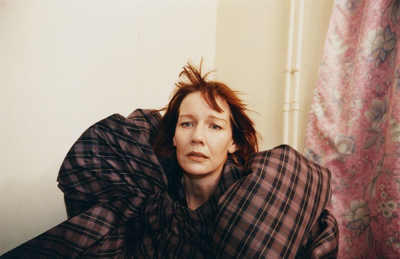 Portrait of actor Sandra Hüller wearing an oversized plaid garment for the Family Style project In the Wings
