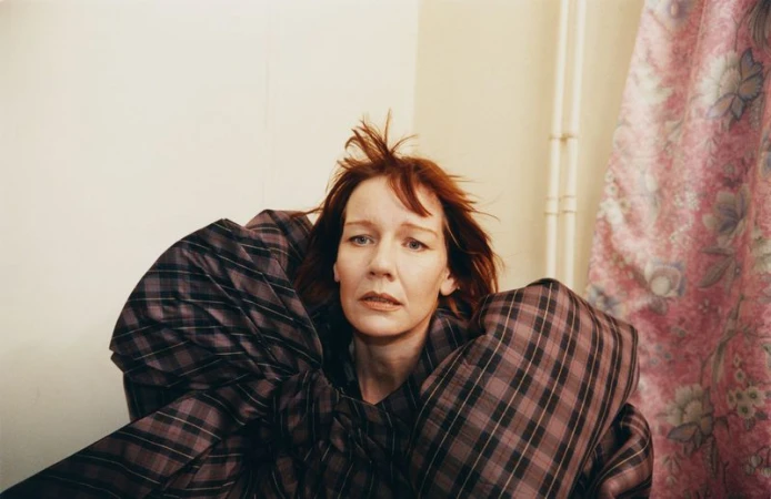 Portrait of actor Sandra Hüller wearing an oversized plaid garment for the Family Style project In the Wings