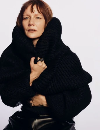 Sandra Hüller wearing a heavy black ribbed sweater against a plain white background for Family Style