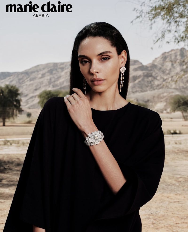 Model Aline Novais wearing diamond jewelry and black dress outdoors with mountain backdrop for Marie Claire Arabia by Lesha Lich